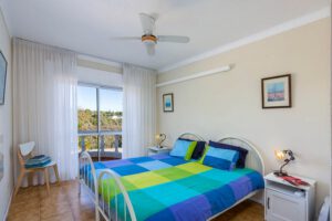 Second bedroom with small balcony with nice view. Shared bathroom with shower and two sinks and toilet