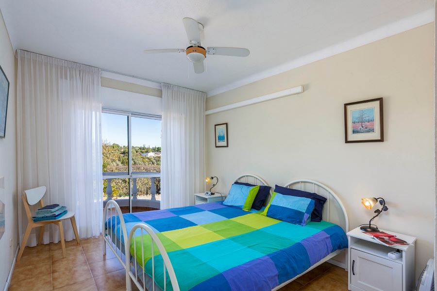 Second bedroom with small balcony with nice view. Shared bathroom with shower and two sinks and toilet